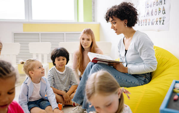 Teacher reading to young pupils